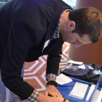 An alumnus signs a wave of encouragement